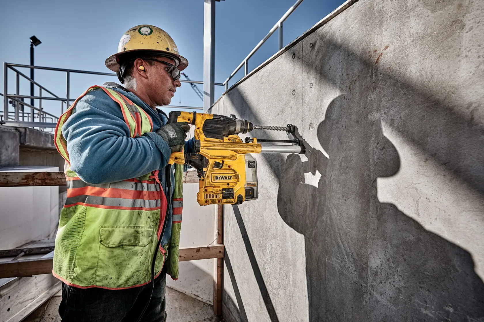 A DEWALT branded rotary hammer drill with a yellow and black body, featuring a side handle and a settings dial for different functions.