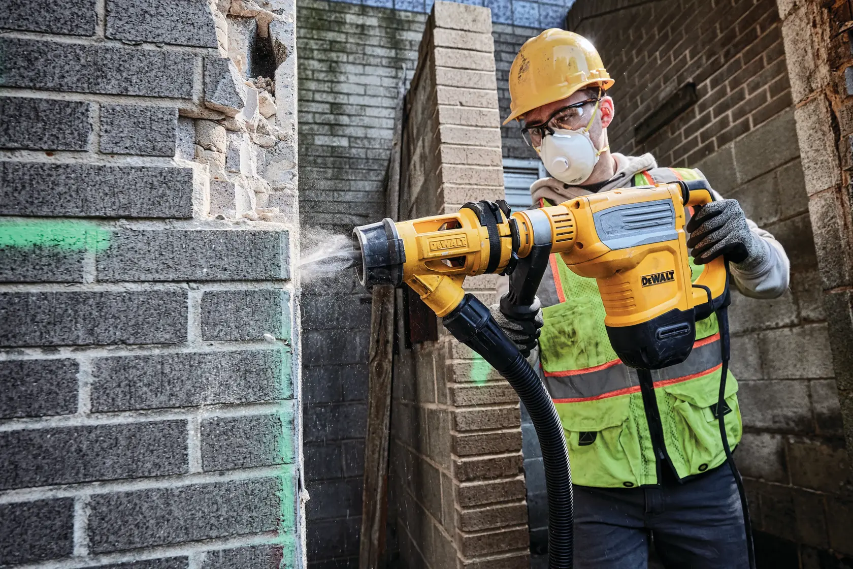 A DEWALT yellow and black electric rotary hammer drill with a side handle, shown against a white background.