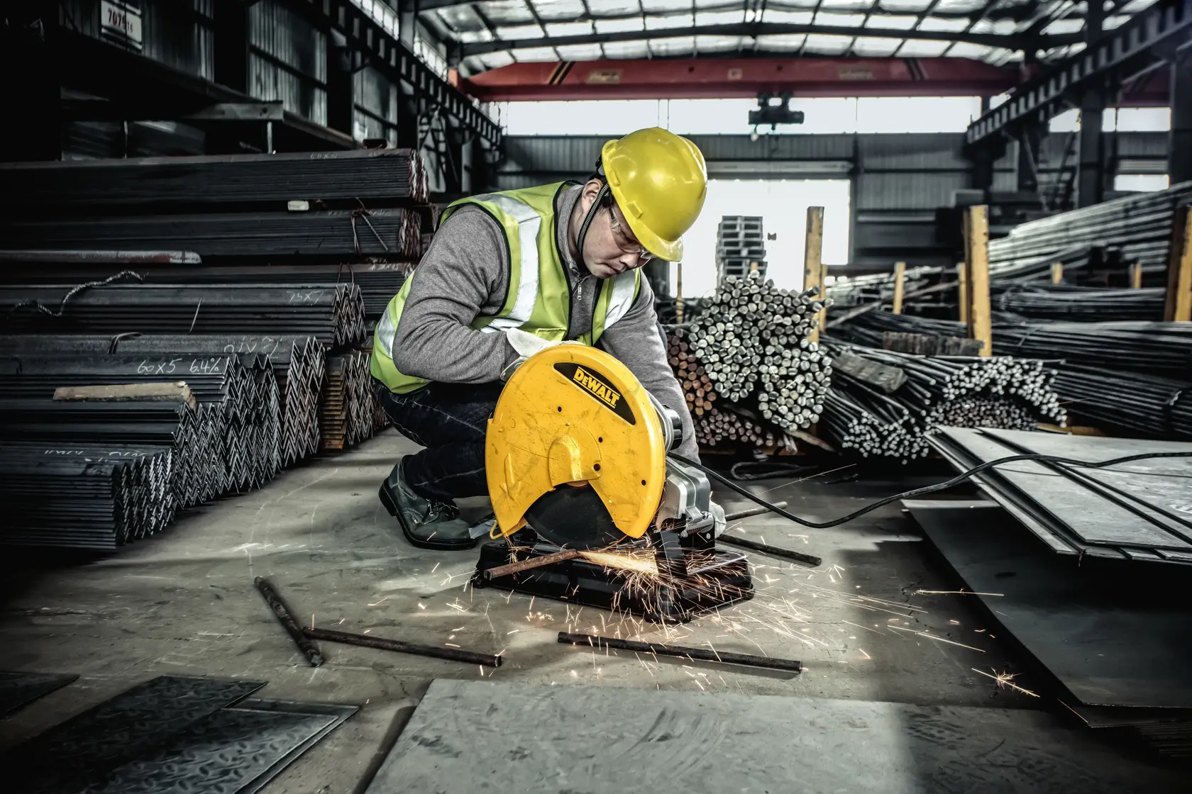 A DEWALT branded portable chop saw with a yellow and black design, featuring a circular cutting blade, a handle, a safety guard, and a sturdy base for metal cutting tasks.
