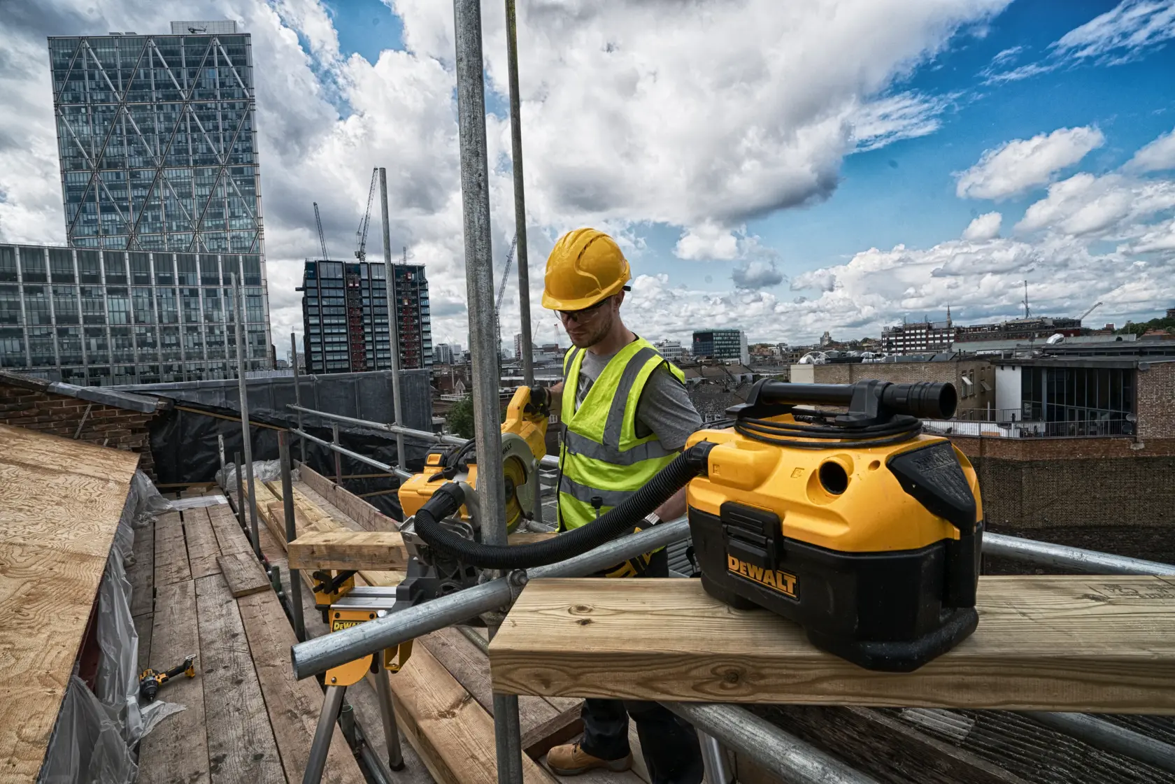 A DEWALT portable wet and dry vacuum cleaner with a yellow and black design, featuring a flexible hose and sturdy handle.