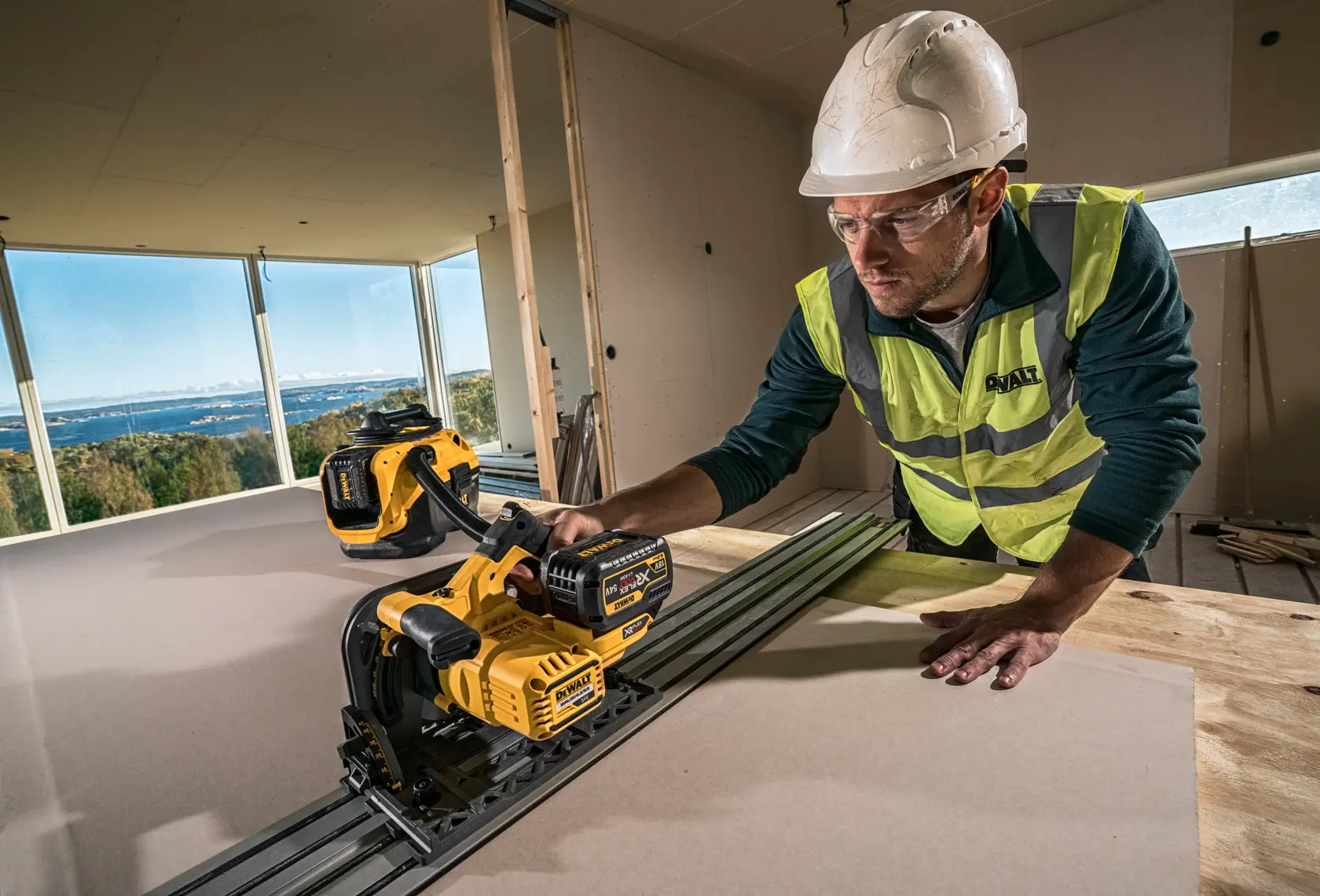 A portable DEWALT vacuum cleaner, model DCV584L, featuring a yellow and black body with a handle, hose attachment, and an easy-access compartment. Designed for robust cleaning in professional or workshop settings.